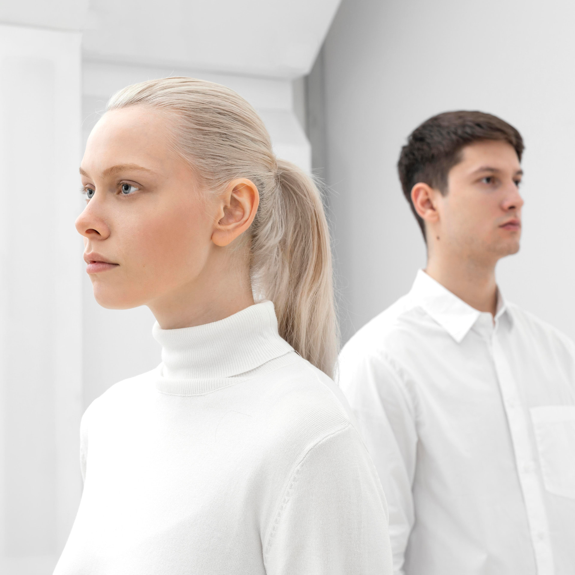 Two professionals standing in a bright minimal interior