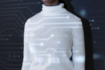 Person in a white turtleneck with a digital circuit pattern projected across them