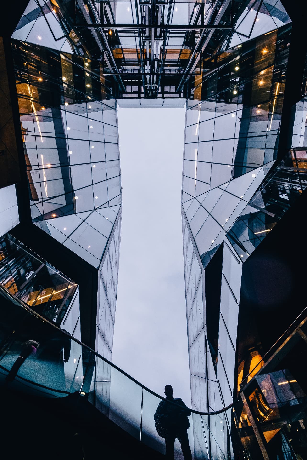 A senior executive standing at a high-rise window considering a strategic decision