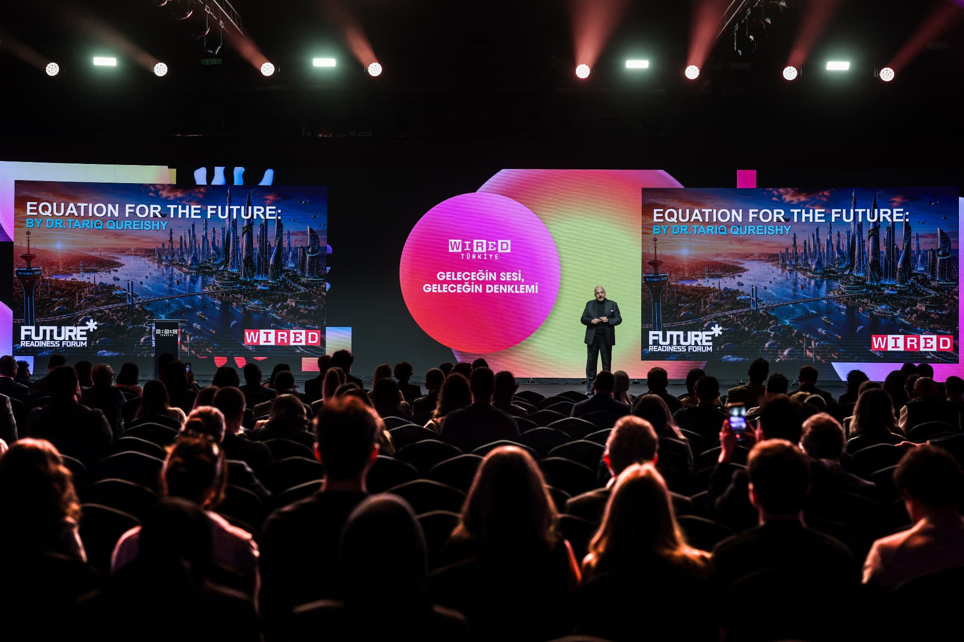 A keynote speaker on stage before an audience